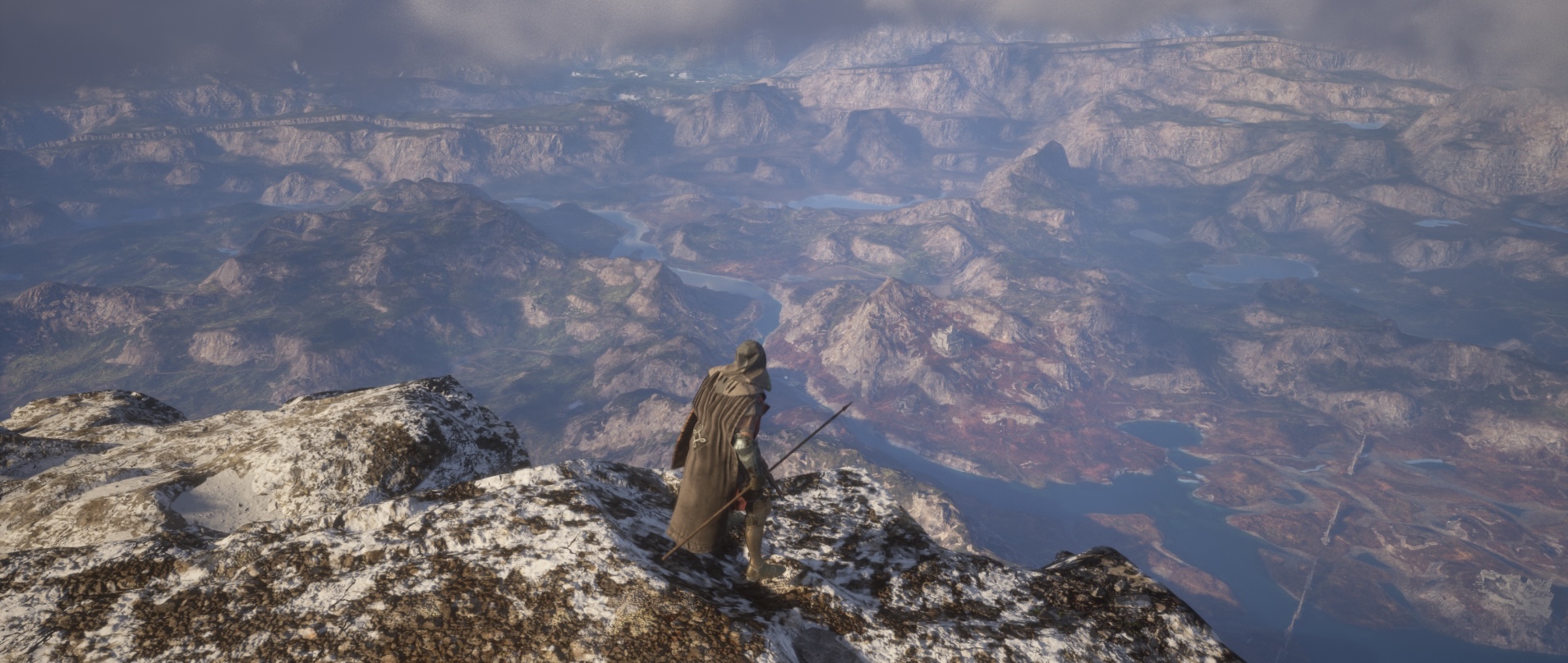 Adventurer in Hood looking down on a valley from a mountain